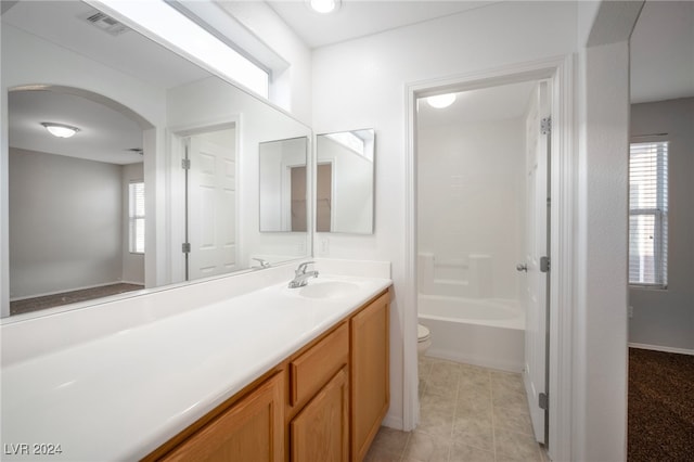 full bathroom with vanity, toilet, shower / bathing tub combination, and plenty of natural light