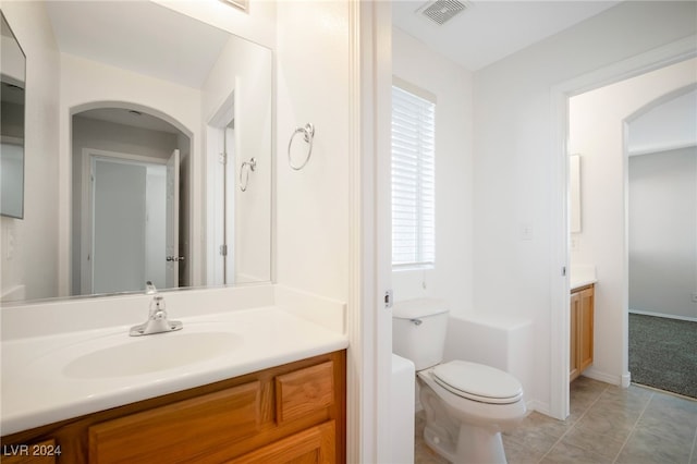 bathroom with vanity, toilet, and tile patterned floors