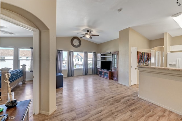 living room featuring lofted ceiling, hardwood / wood-style flooring, and a healthy amount of sunlight