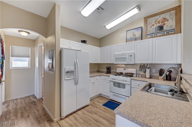 kitchen featuring white appliances, light hardwood / wood-style floors, sink, and white cabinets