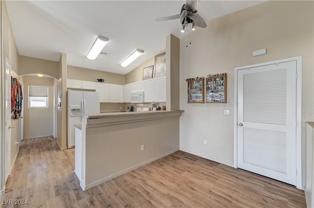 kitchen featuring kitchen peninsula, white cabinetry, light wood-type flooring, and white appliances