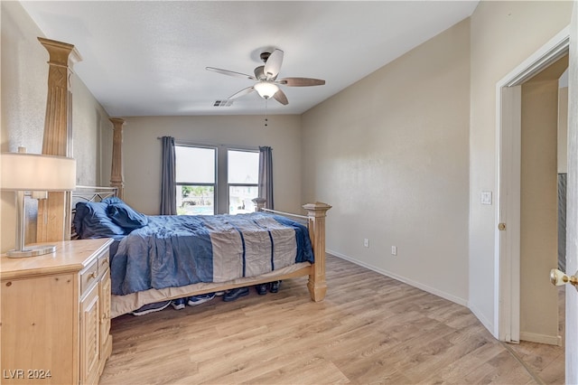 bedroom featuring light hardwood / wood-style flooring, lofted ceiling, and ceiling fan