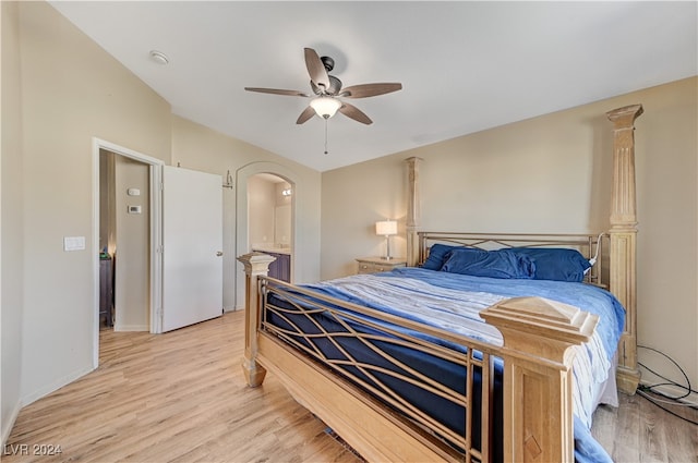 bedroom with ensuite bath, light wood-type flooring, and ceiling fan