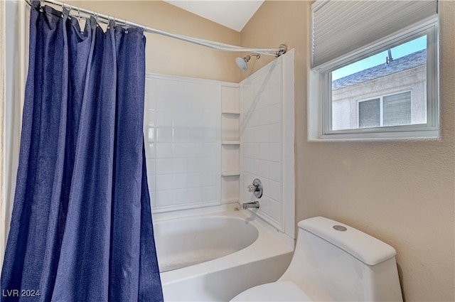 bathroom with vaulted ceiling, toilet, and shower / bathtub combination with curtain