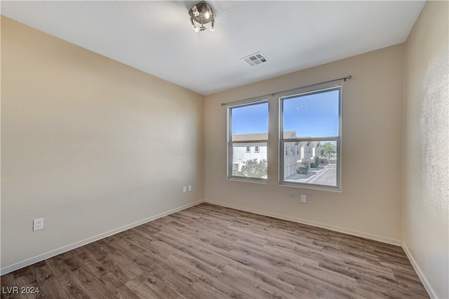 spare room featuring hardwood / wood-style flooring