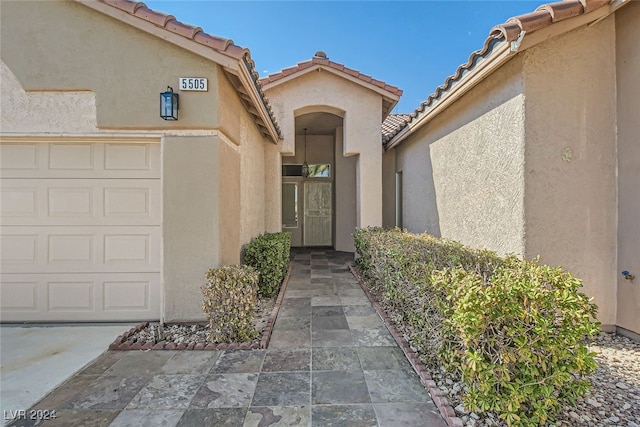 view of exterior entry with a garage