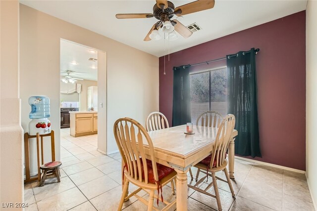 tiled dining room featuring ceiling fan