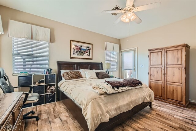 bedroom with light hardwood / wood-style floors and ceiling fan