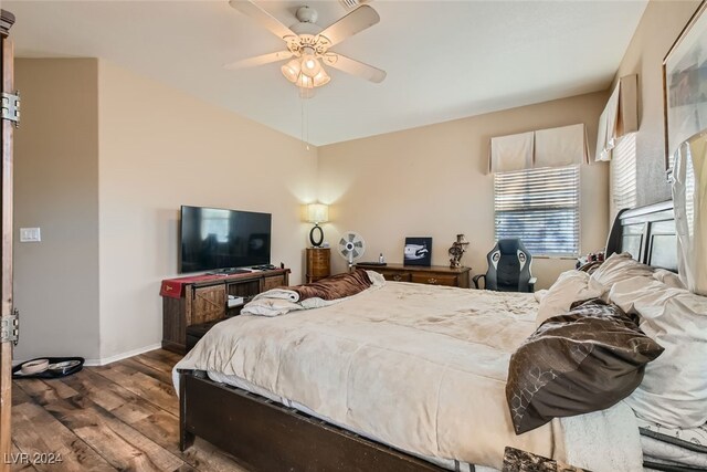 bedroom featuring ceiling fan and dark hardwood / wood-style flooring