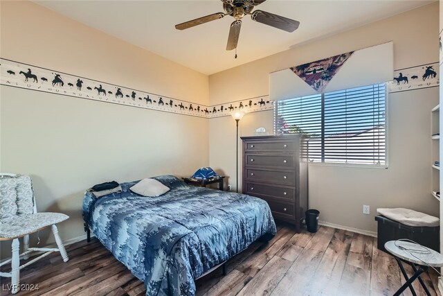 bedroom featuring dark hardwood / wood-style flooring and ceiling fan