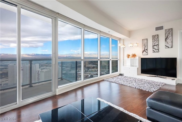 living area with visible vents and wood finished floors