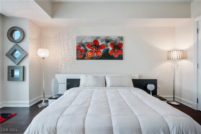 bedroom featuring baseboards and wood finished floors