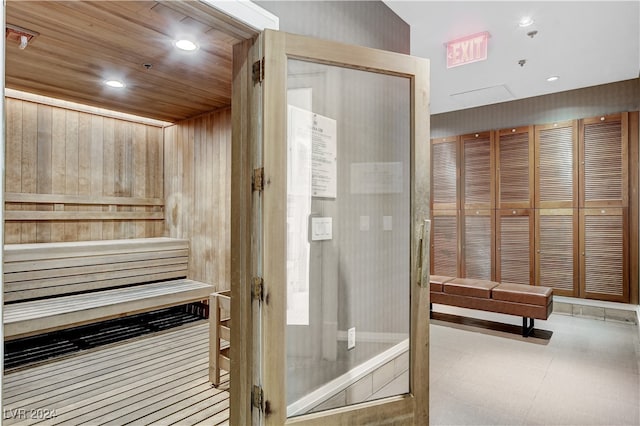 view of sauna / steam room with wood ceiling and wooden walls