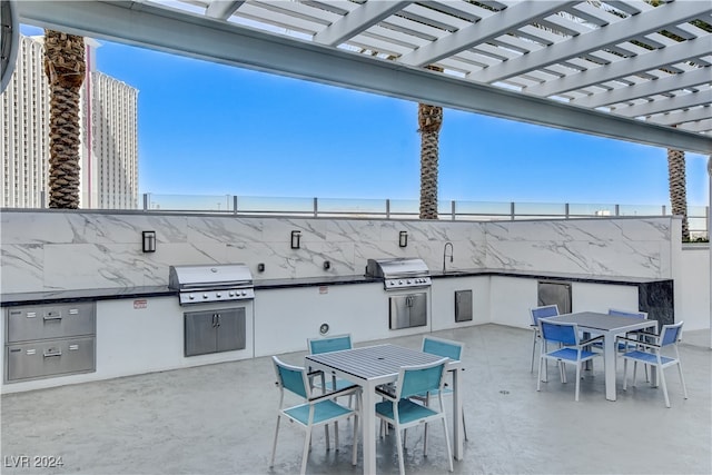 view of patio with a pergola, area for grilling, and sink