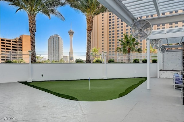 surrounding community with fence and a city view