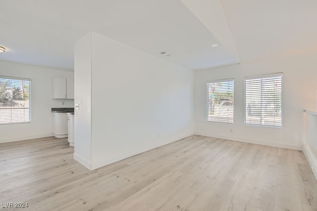 empty room featuring light hardwood / wood-style flooring and a healthy amount of sunlight