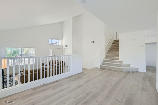 empty room featuring light hardwood / wood-style floors and high vaulted ceiling