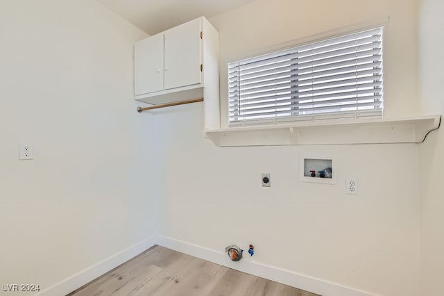 clothes washing area featuring cabinets, washer hookup, light wood-type flooring, and a wealth of natural light