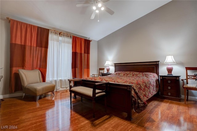 bedroom with ceiling fan, vaulted ceiling, and hardwood / wood-style floors