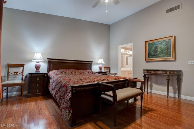 bedroom featuring connected bathroom, ceiling fan, and wood-type flooring