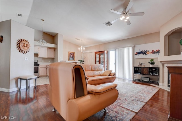 living room featuring ceiling fan with notable chandelier and dark hardwood / wood-style floors