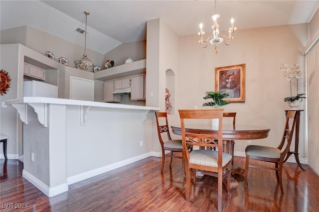 dining room featuring a notable chandelier, vaulted ceiling, and dark hardwood / wood-style floors