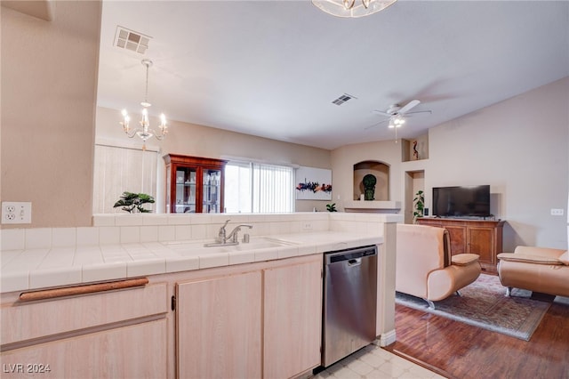 kitchen featuring tile countertops, dishwasher, ceiling fan with notable chandelier, and light hardwood / wood-style floors