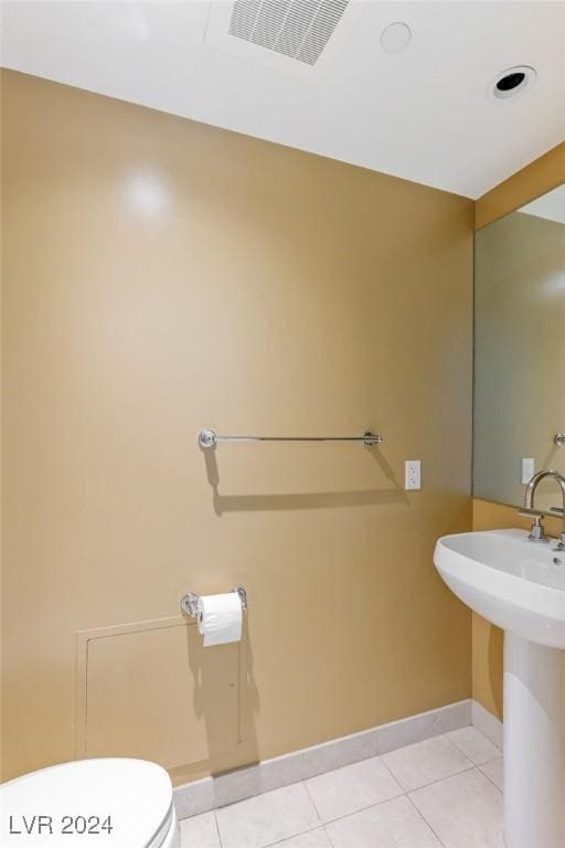 bathroom featuring tile patterned floors, sink, and toilet