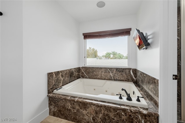 bathroom featuring a relaxing tiled tub and tile patterned floors