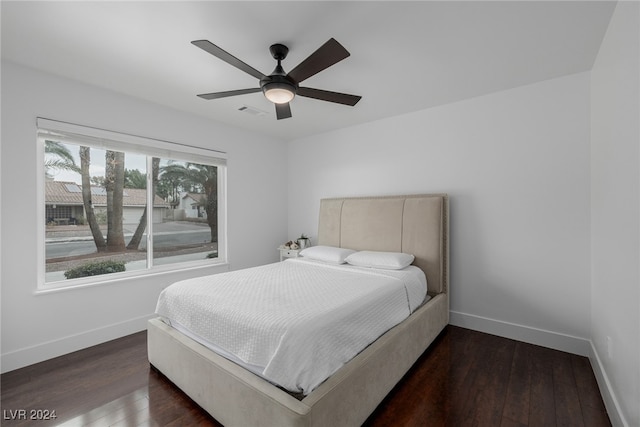 bedroom with dark hardwood / wood-style floors and ceiling fan