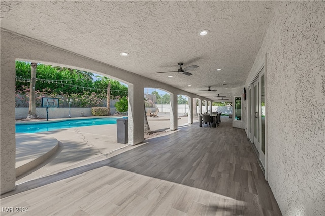 exterior space featuring a fenced in pool, a patio, and ceiling fan