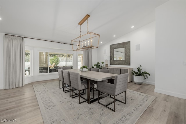 dining area featuring an inviting chandelier, light hardwood / wood-style flooring, and lofted ceiling