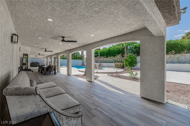 view of patio with a fenced in pool and ceiling fan