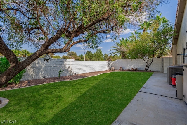 view of yard featuring cooling unit and a patio area