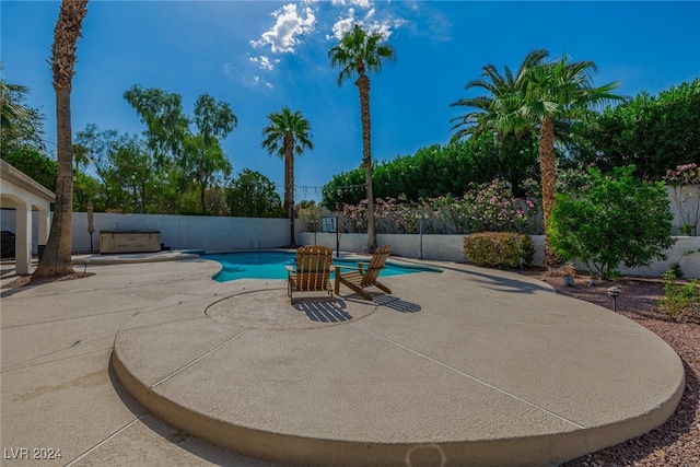 view of pool with a hot tub and a patio area