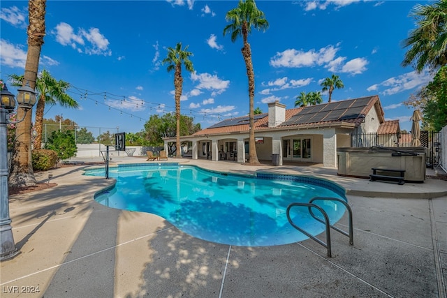 view of swimming pool with a hot tub and a patio