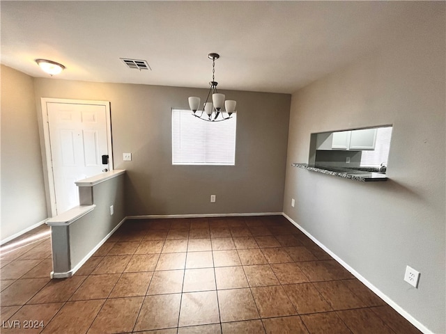 unfurnished dining area featuring a notable chandelier and a healthy amount of sunlight