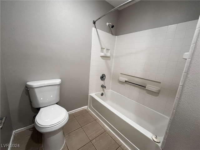 bathroom with toilet, tile patterned floors, and washtub / shower combination