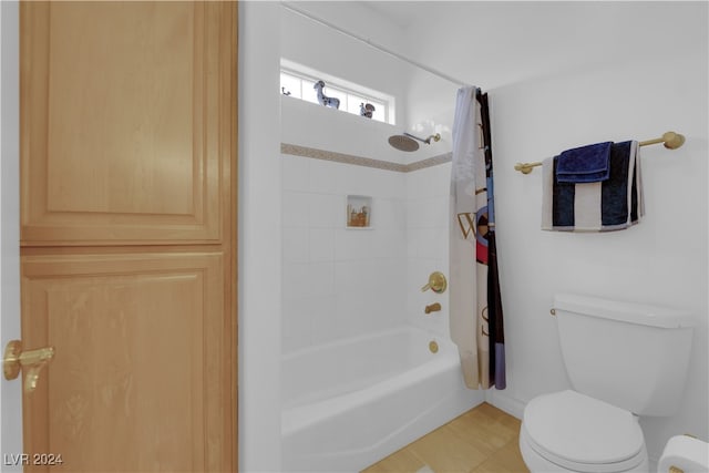 bathroom with toilet, tile patterned floors, and shower / tub combo