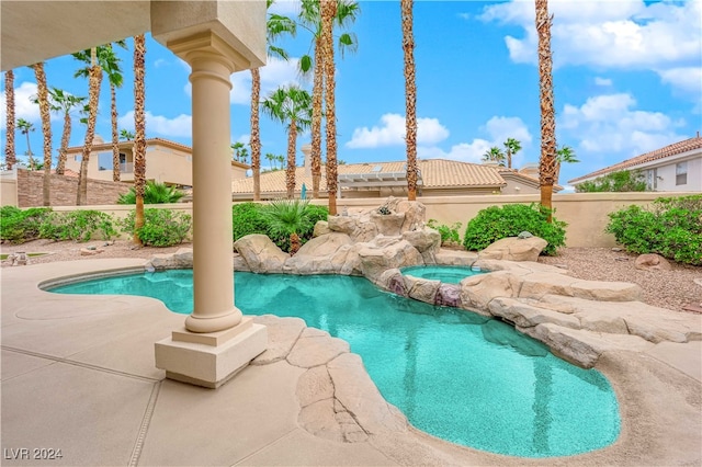 view of pool featuring an in ground hot tub and a patio