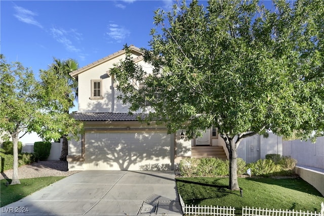 view of front of house featuring a front yard and a garage