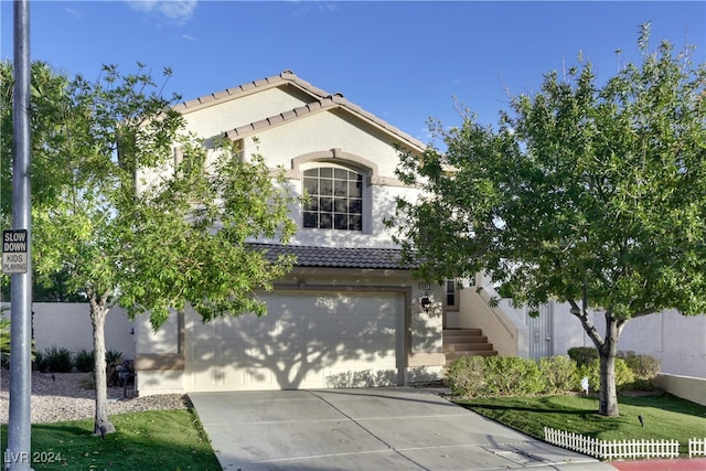 mediterranean / spanish-style house with a garage