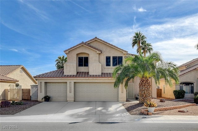 mediterranean / spanish-style home with a garage