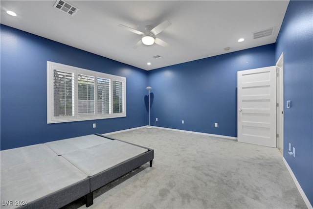 unfurnished bedroom with ceiling fan and light colored carpet