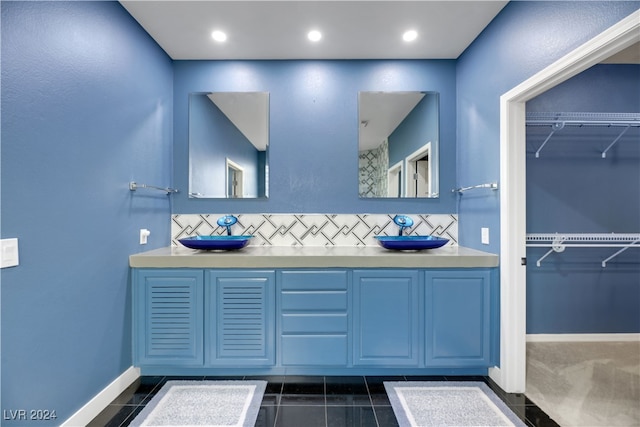 bathroom featuring vanity, tile patterned floors, and decorative backsplash