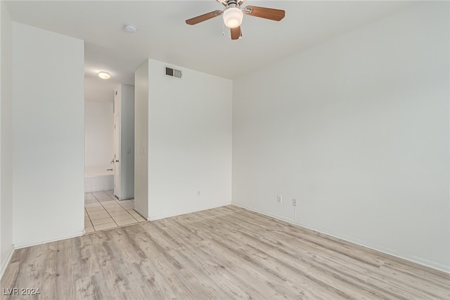 empty room with light hardwood / wood-style floors and ceiling fan