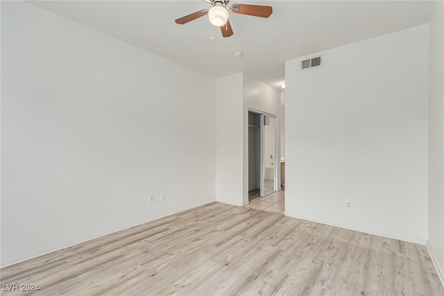 unfurnished room featuring light wood-type flooring and ceiling fan