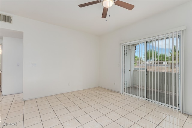 spare room featuring ceiling fan and light tile patterned floors