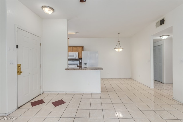 kitchen featuring kitchen peninsula, hanging light fixtures, white appliances, and light tile patterned floors