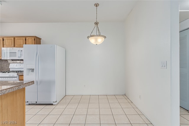 kitchen featuring backsplash, hanging light fixtures, white appliances, and light tile patterned floors